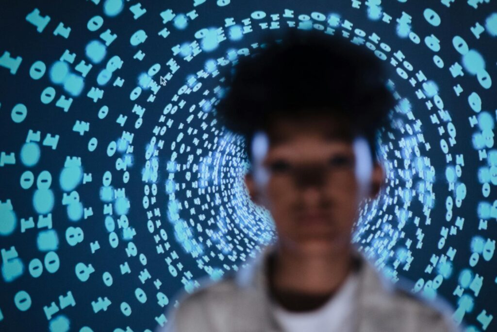 Abstract image of a woman in front of a matrix of numbers, illustrating clarity, self-awareness, and transformation through inner work